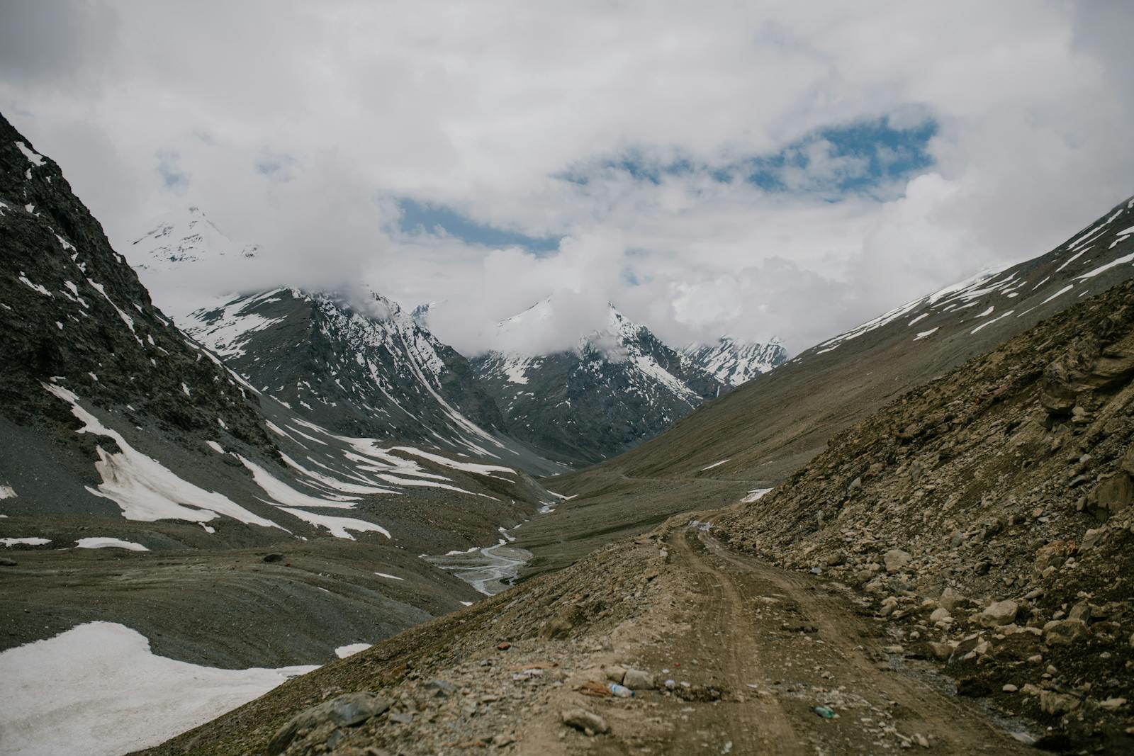 A Himalayan mountain road and valley under clear daylight